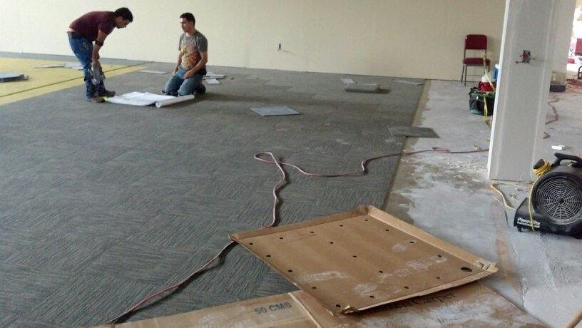 Commercial carpet tile installation in progress